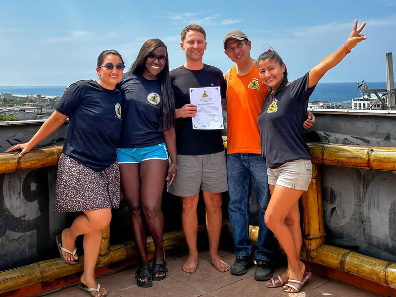 Teilnehmender zeigt stolz das Zertifikat eines Kursteilnehmenden an der Montañita Spanish School