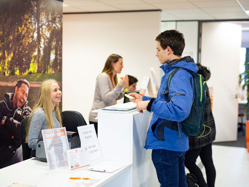 Schüler im Empfangsbereich beim Check-in der Sprachschule