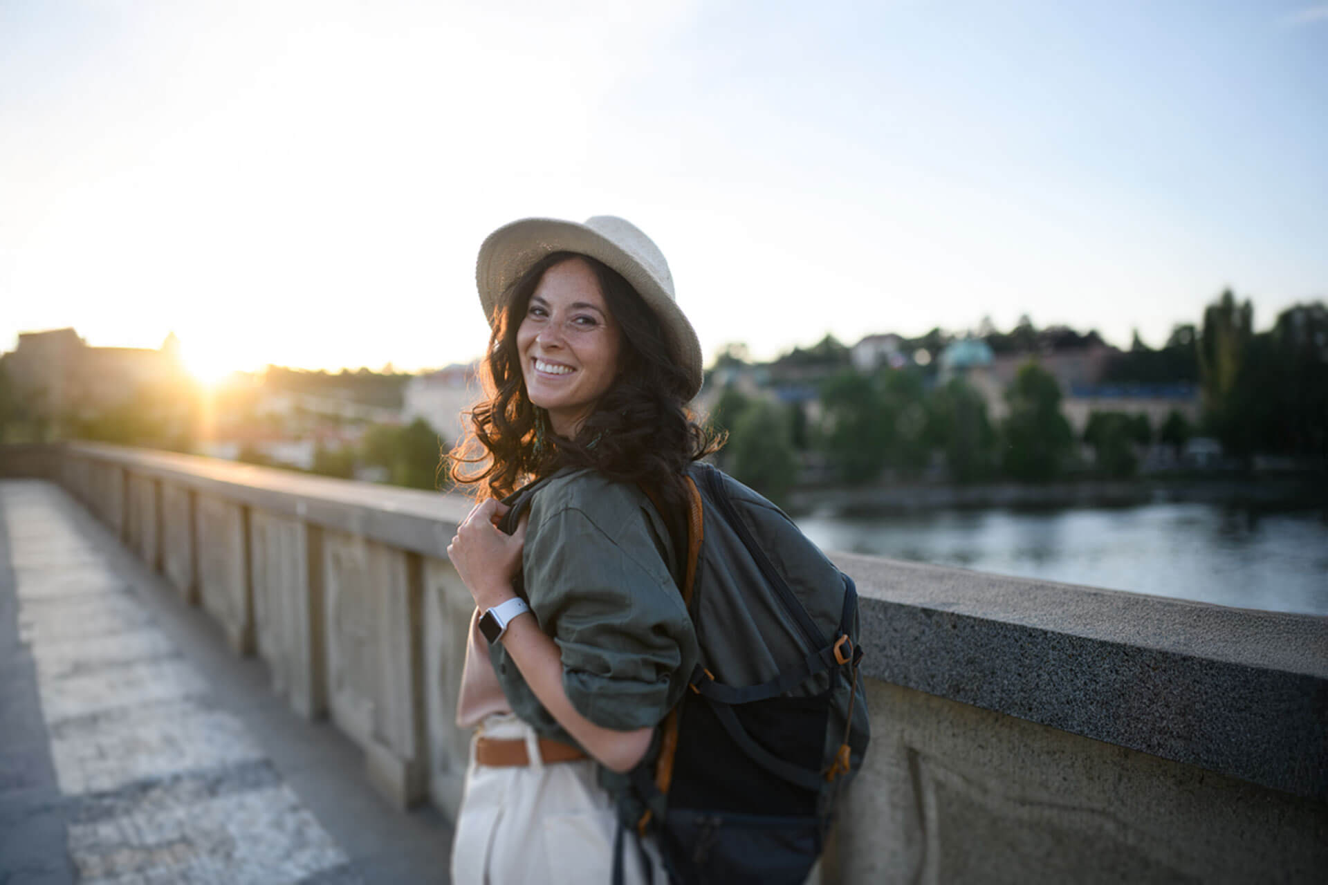 Frau mit Rucksack genießt den Sonnenuntergang an der Rhône in Lyon