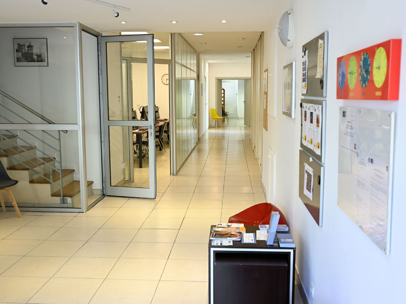 Hall lumineux de l'école de langue française Les Ateliers FL à Nice avec salles de cours et espace d'information.