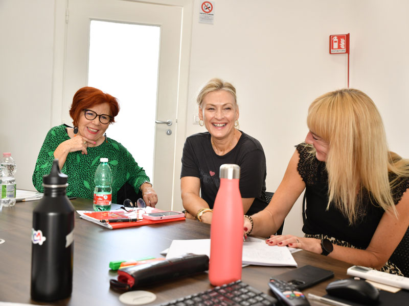 Drei Teilnehmerinnen lachen gemeinsam während einer Unterrichtseinheit