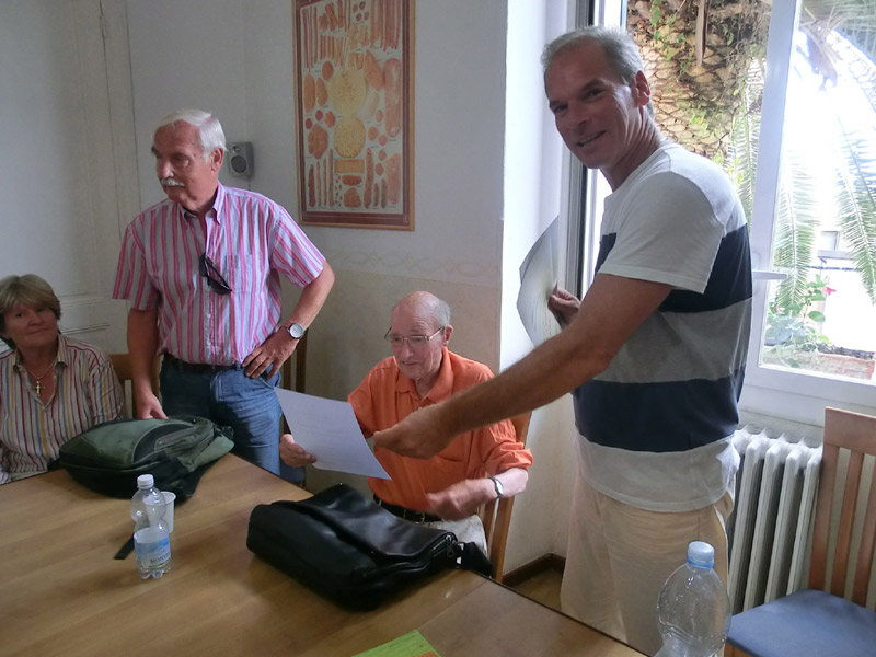 Erwachsene Sprachschüler erhalten Kursunterlagen und Zertifikate im Unterrichtsraum