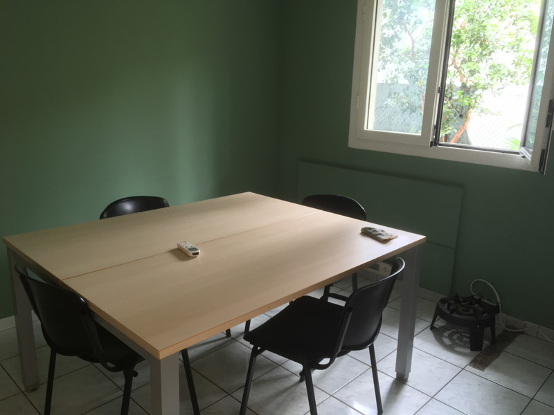 Kleiner Unterrichtsraum mit grün gestrichener Wand und Tageslicht durch das geöffnete Fenster