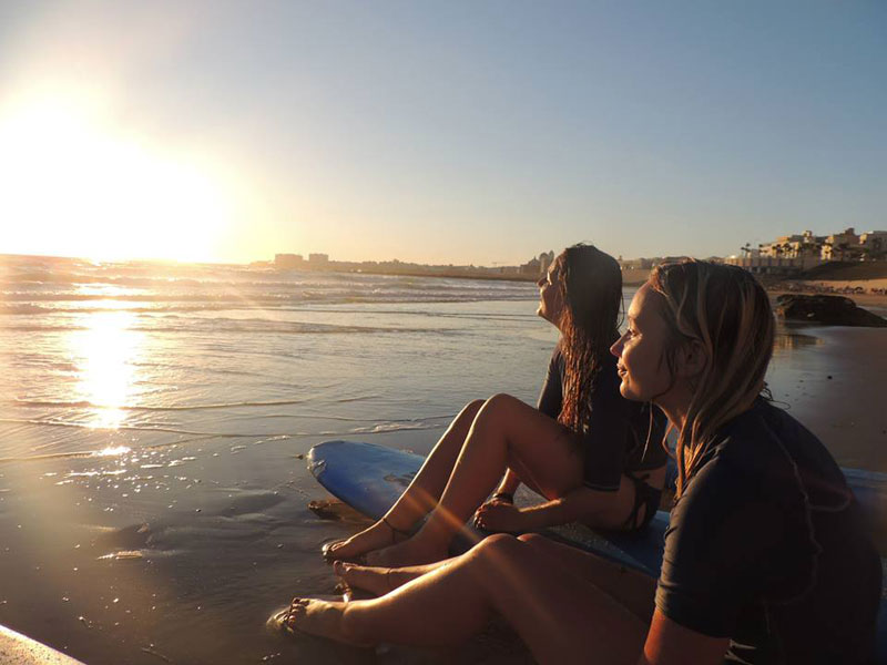 Teilnehmende genießen den Sonnenuntergang am Strand von Cádiz