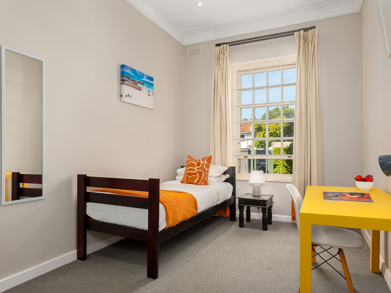 Camera singola nella residenza con letto, scrivania e molta luce naturale