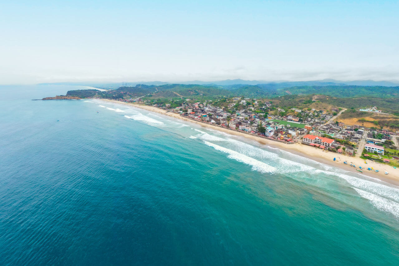 Luftaufnahme von Montañita mit Strand, Meer und umliegender Landschaft in Ecuador
