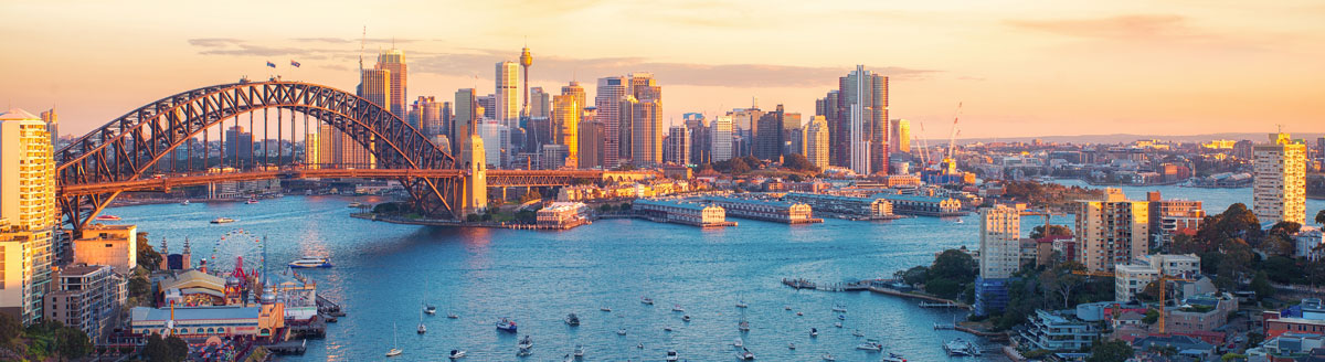 Sydney Harbour Bridge und Skyline bei Sonnenuntergang als beeindruckendes Motiv für Englisch-Sprachreisen nach Australien